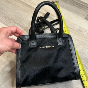 New w/o tags. Still has the plastic (never worn) Vera Bradley faux fur mini bag